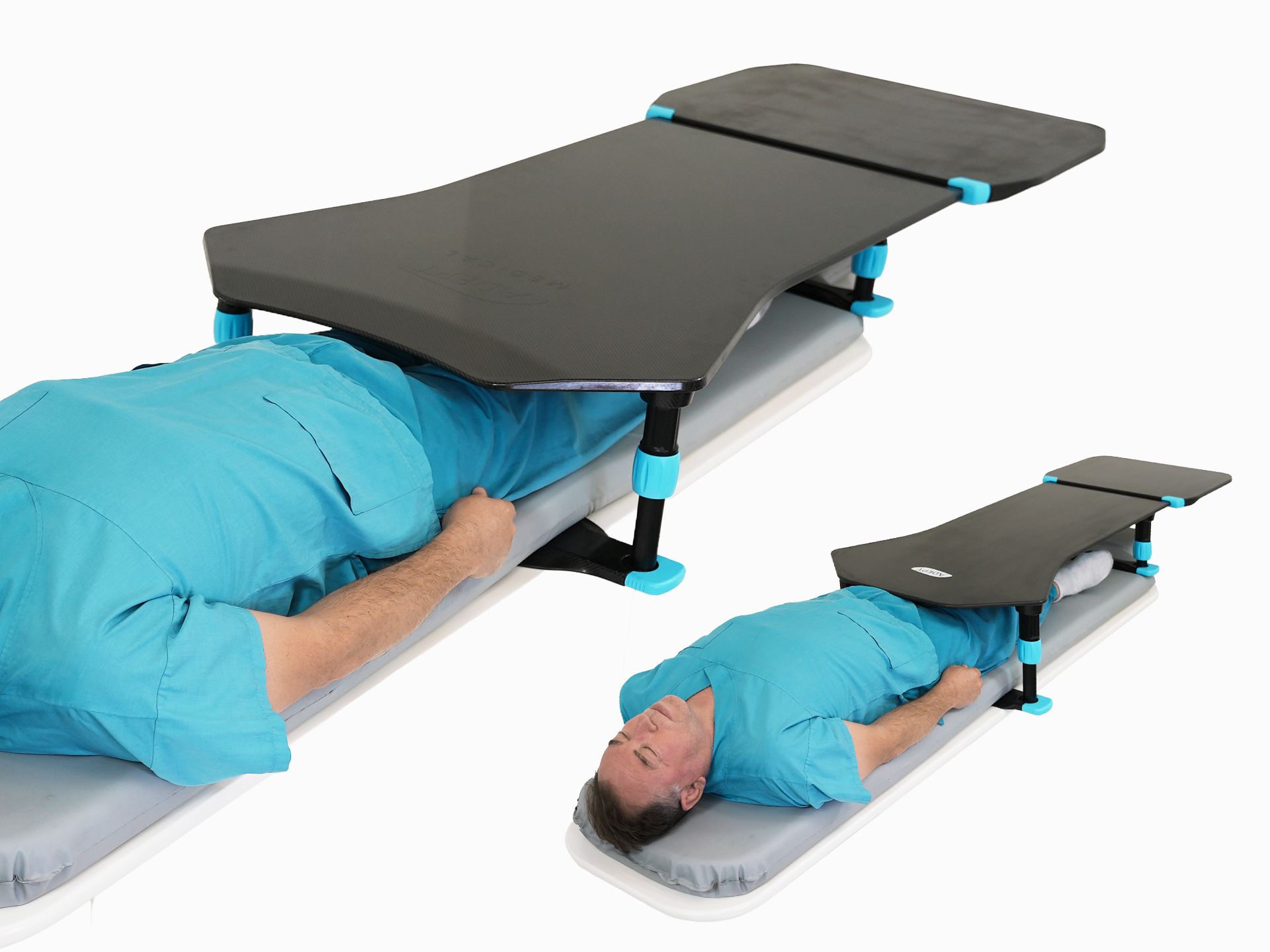A person lies on a medical bed with a dark gray and blue adjustable support table over their lower body.